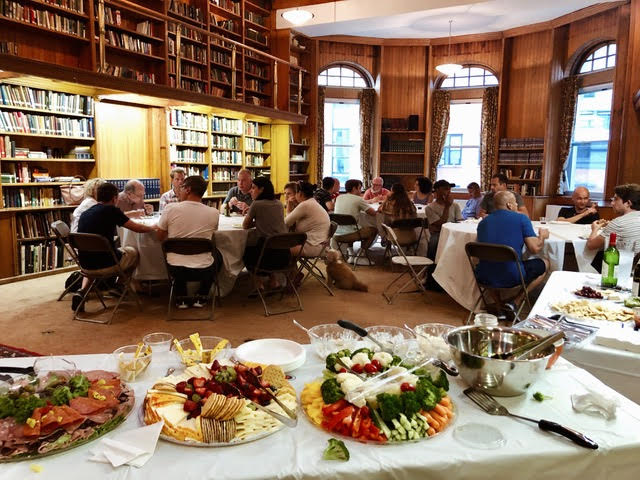 Participants sitting around a table at Thrive For Life's monthly community dinner