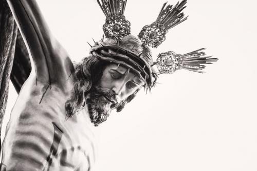 image: black and white image of a crucifix, close-up on Jesus' face