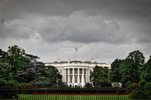 Image of white house in front of dark, ominous sky