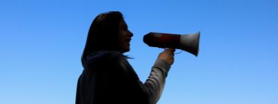 silhouette of woman holding megaphone