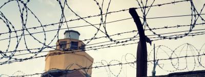 barbed wire around prison watch tower