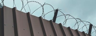 cement wall with barbed wire