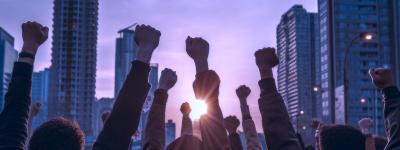 people with hands raised in advocacy