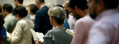 people praying in filled church pews