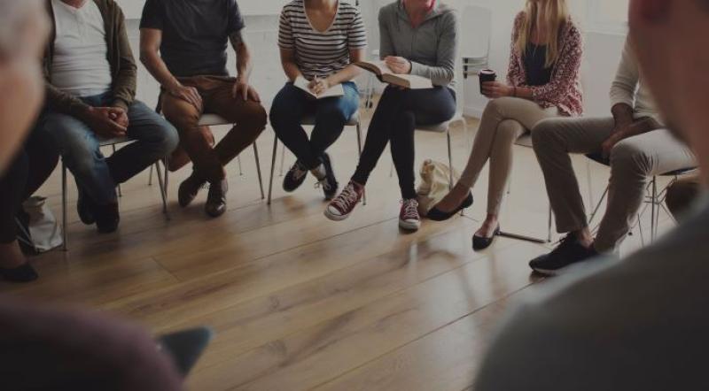 people sitting in chairs in a circle