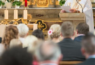 priest preaching to congregation