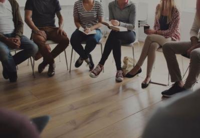 people sitting in chairs in a circle