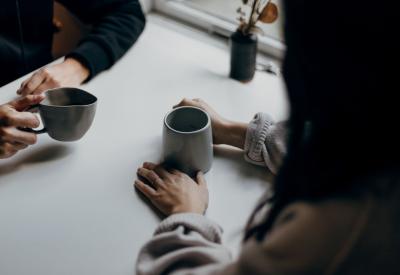 people converse over coffee