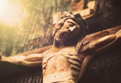 Wooden crucifix with light beaming from one corner